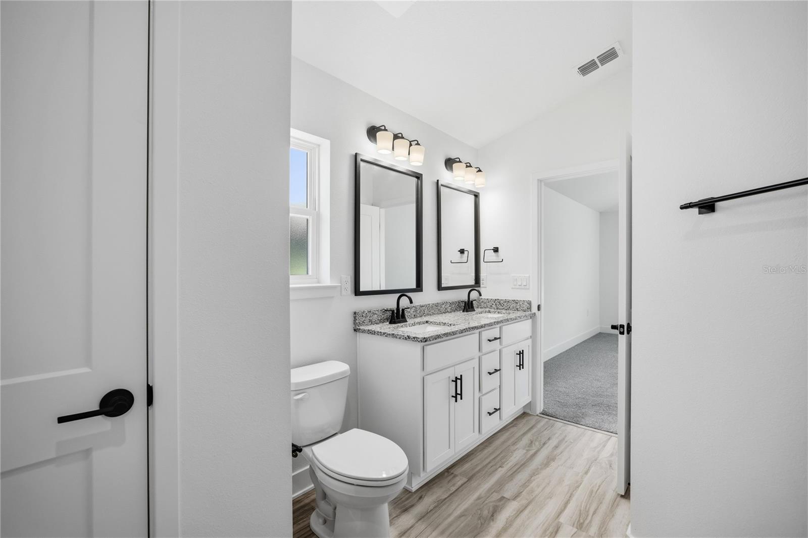 Modern bathroom with white vanity and double sinks