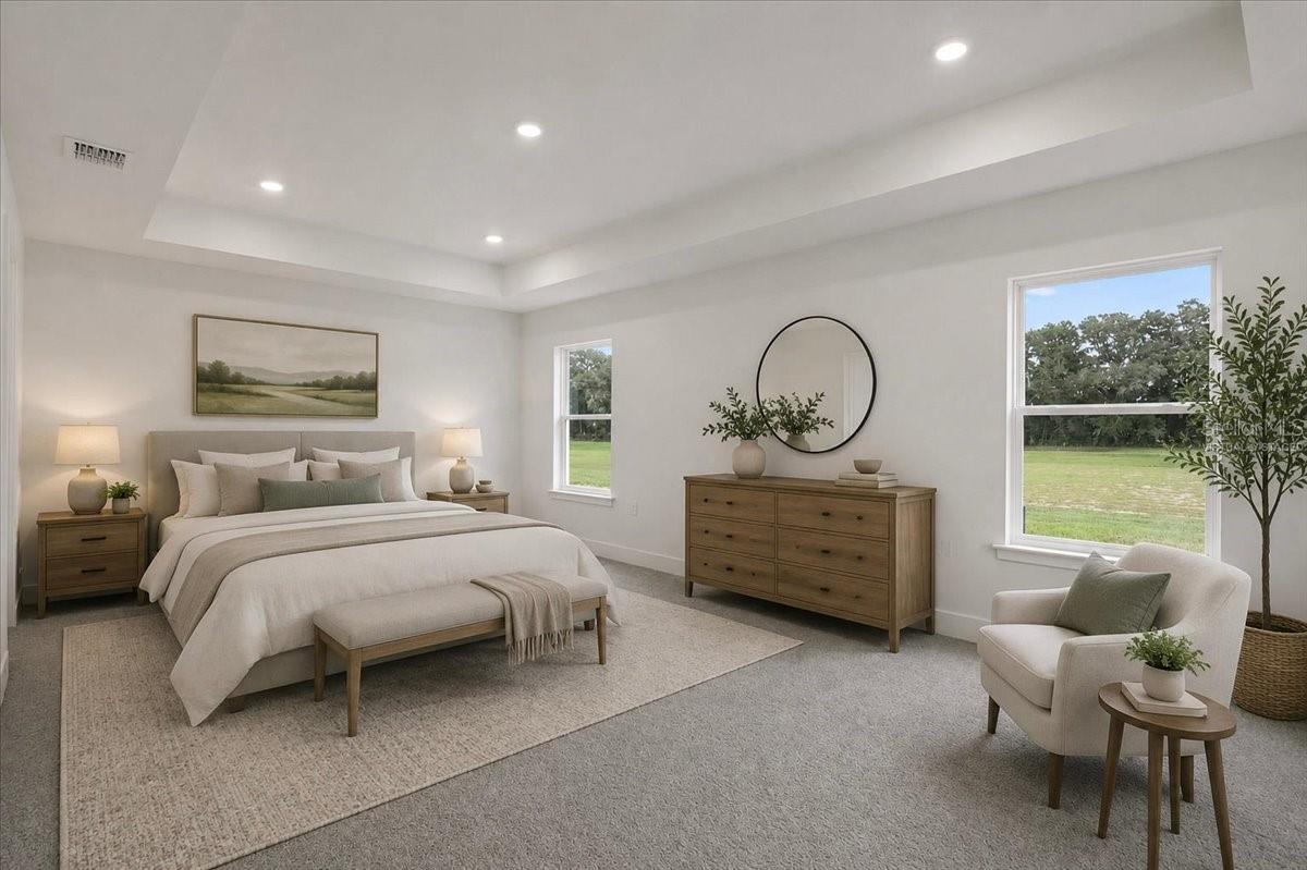 A bright and airy master bedroom with a neutral color palette featuring a bed, dresser, accent chair, and large windows with a view of a field.