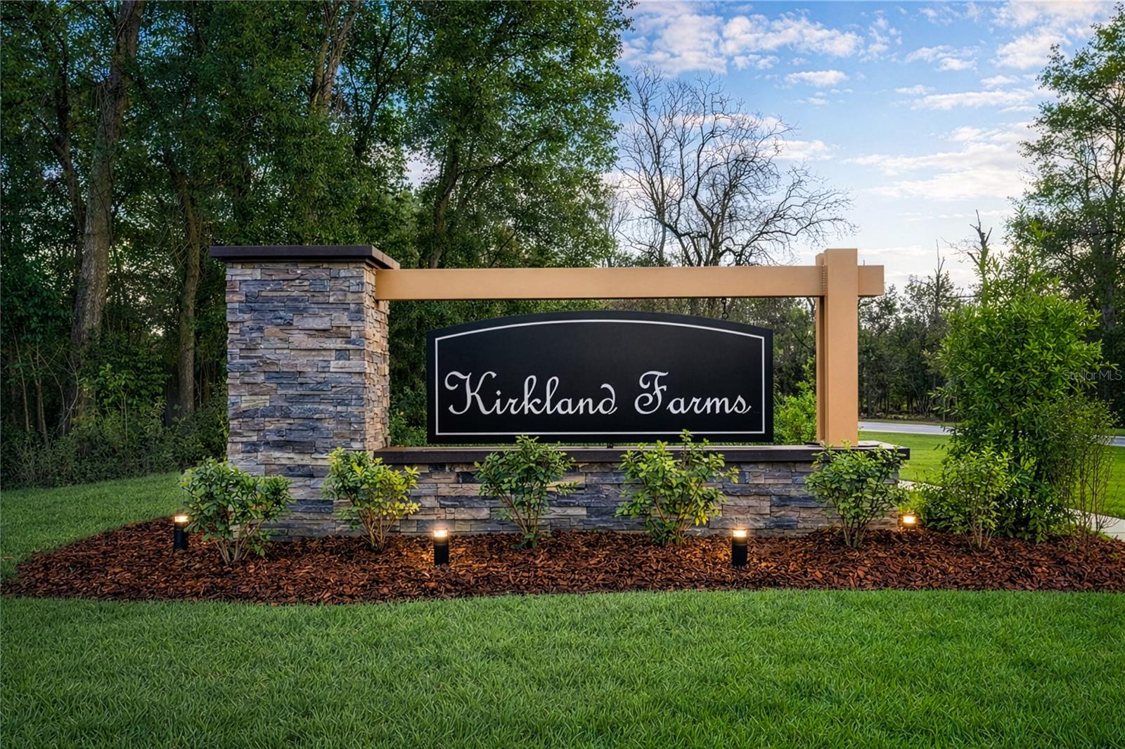 The Kirkland Farms neighborhood entrance sign featuring stone masonry and modern design