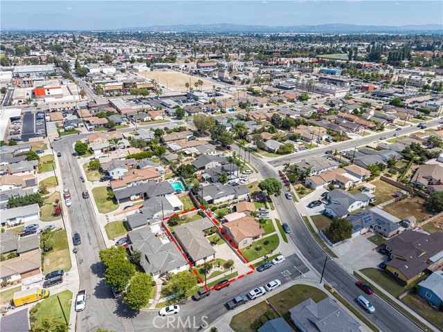 Aerial drone shot showing the residential lot with a red outline highlighting the property boundaries in a suburban neighborhood.