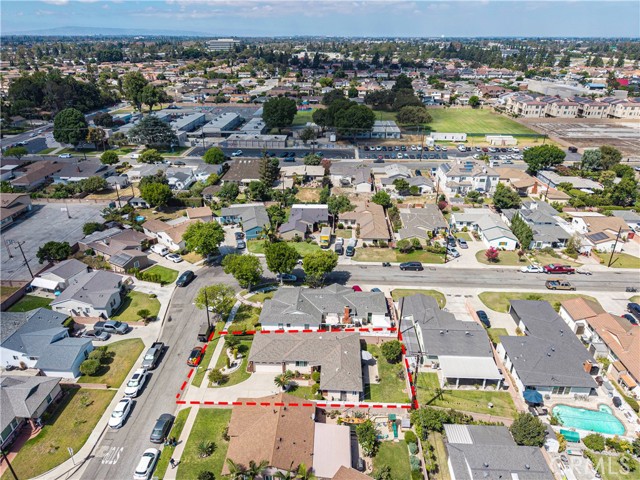 Aerial view of a residential home highlighting the lot boundary in red lines