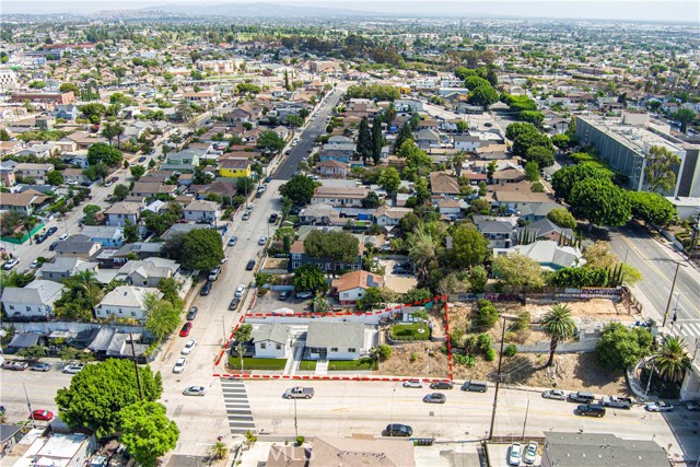 Aerial view of a residential property outlined in red in a suburban neighborhood