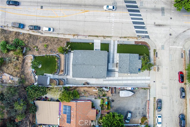 Aerial view showing the property lot layout with buildings, driveway, and landscaping