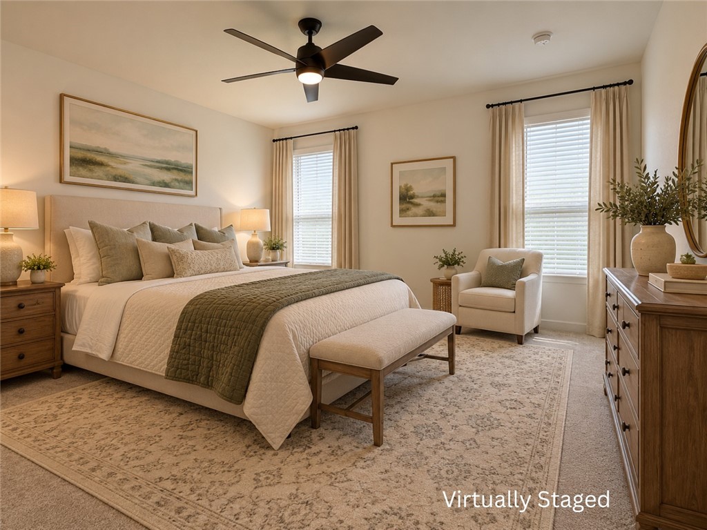 Virtually staged bedroom with a large bed, upholstered bench, and two bright windows.