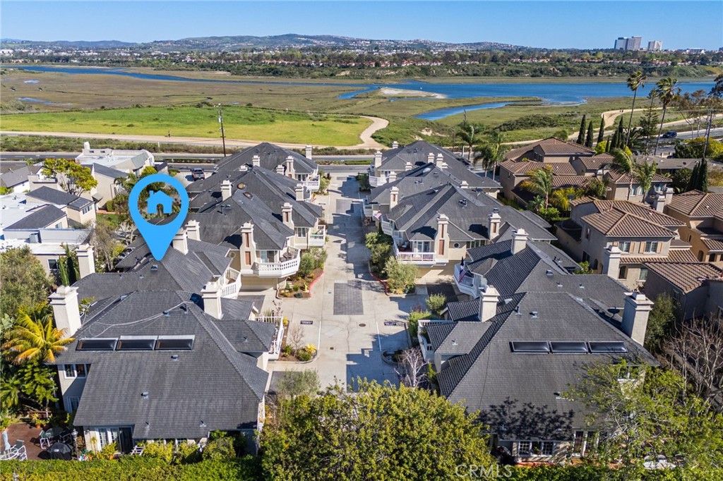 Aerial view of homes beside coastal wetlands and waterways.