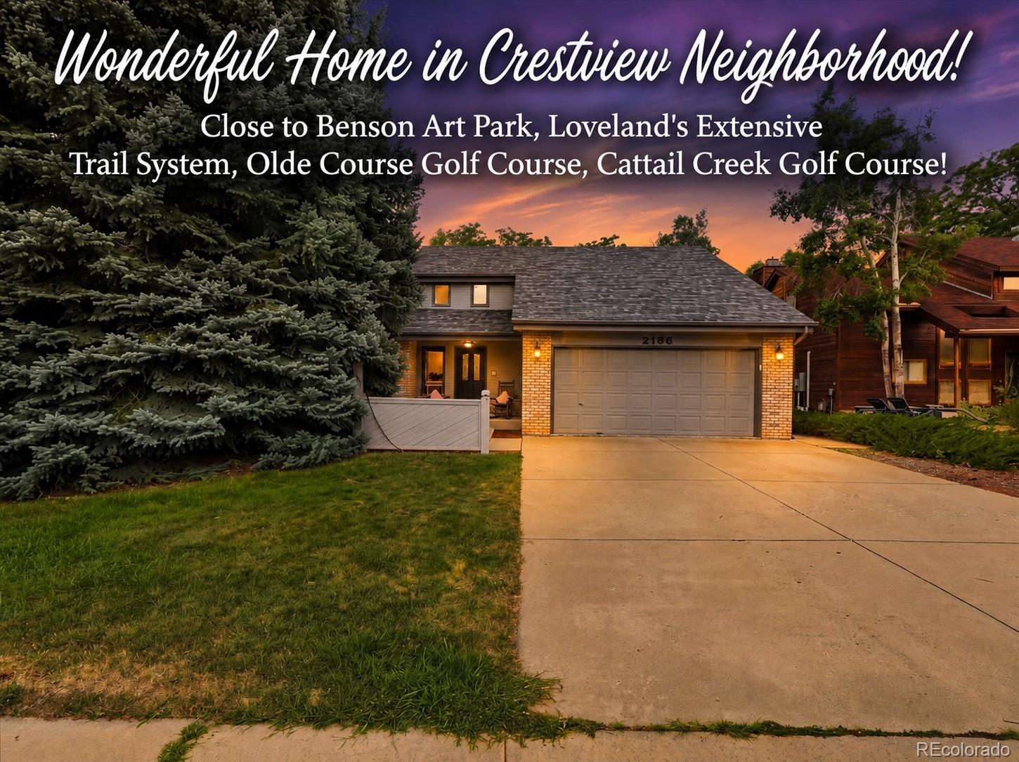 Crestview home at dusk with a broad driveway, two-car garage, and large evergreen tree.