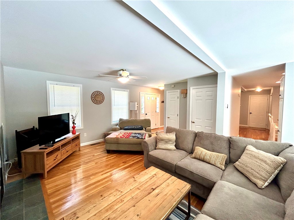 Furnished living room with a gray sectional, wood coffee table, and vaulted ceiling.