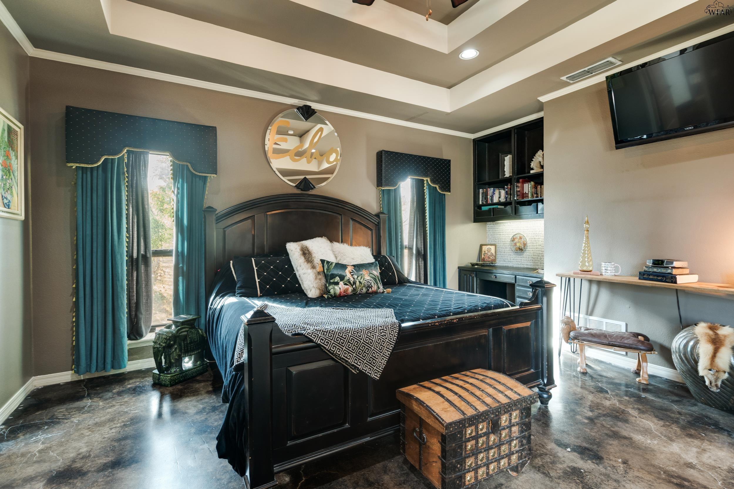 Bedroom with a dark four-poster bed, teal curtains, and a round “Echo” mirror above the headboard.