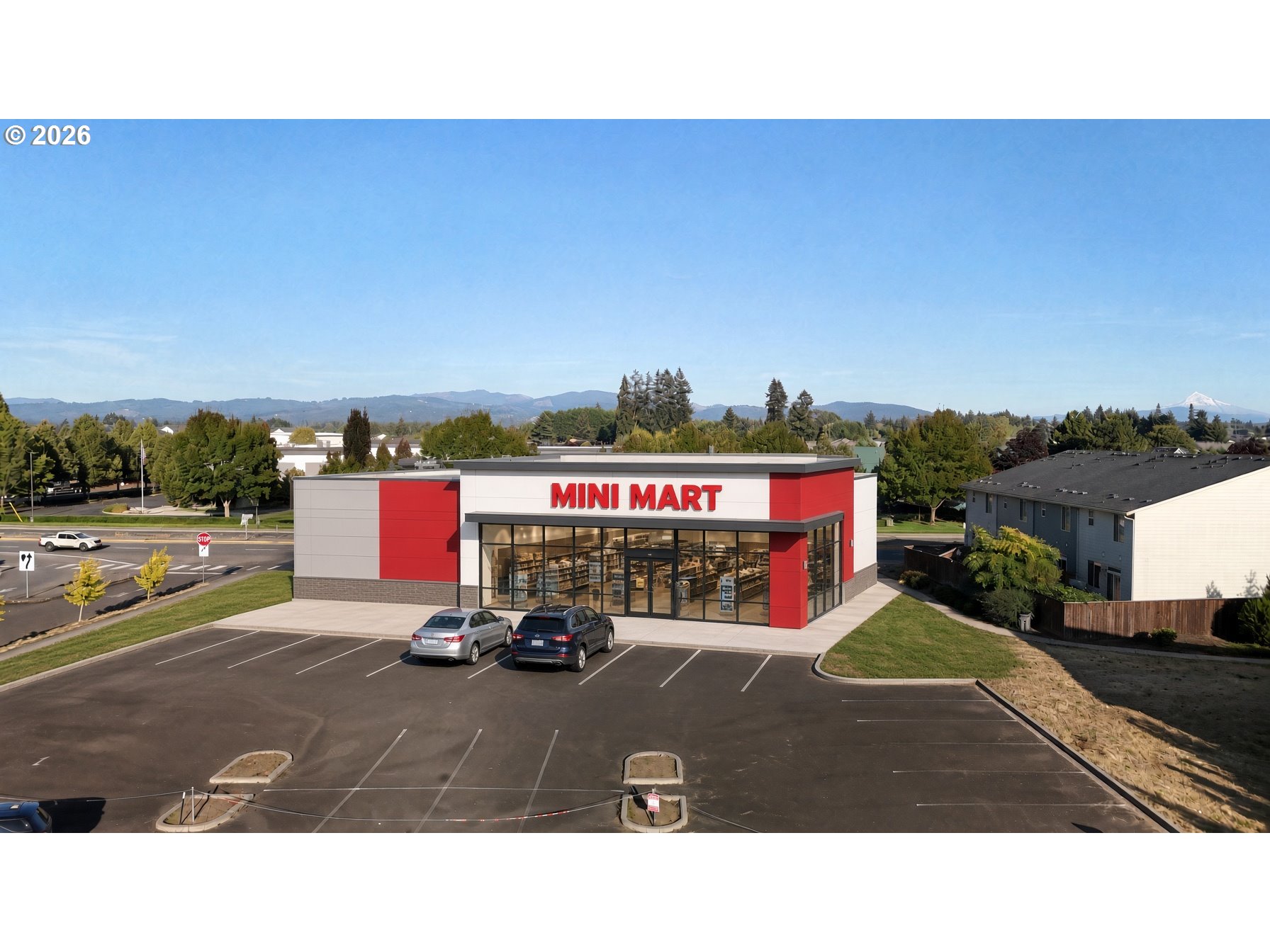 Red-and-white mini mart with a broad parking lot and distant mountains.
