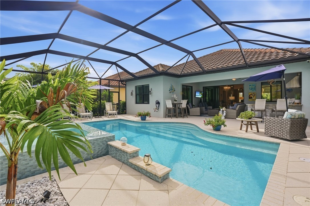Backyard pool and screened lanai with outdoor dining and lounge areas.