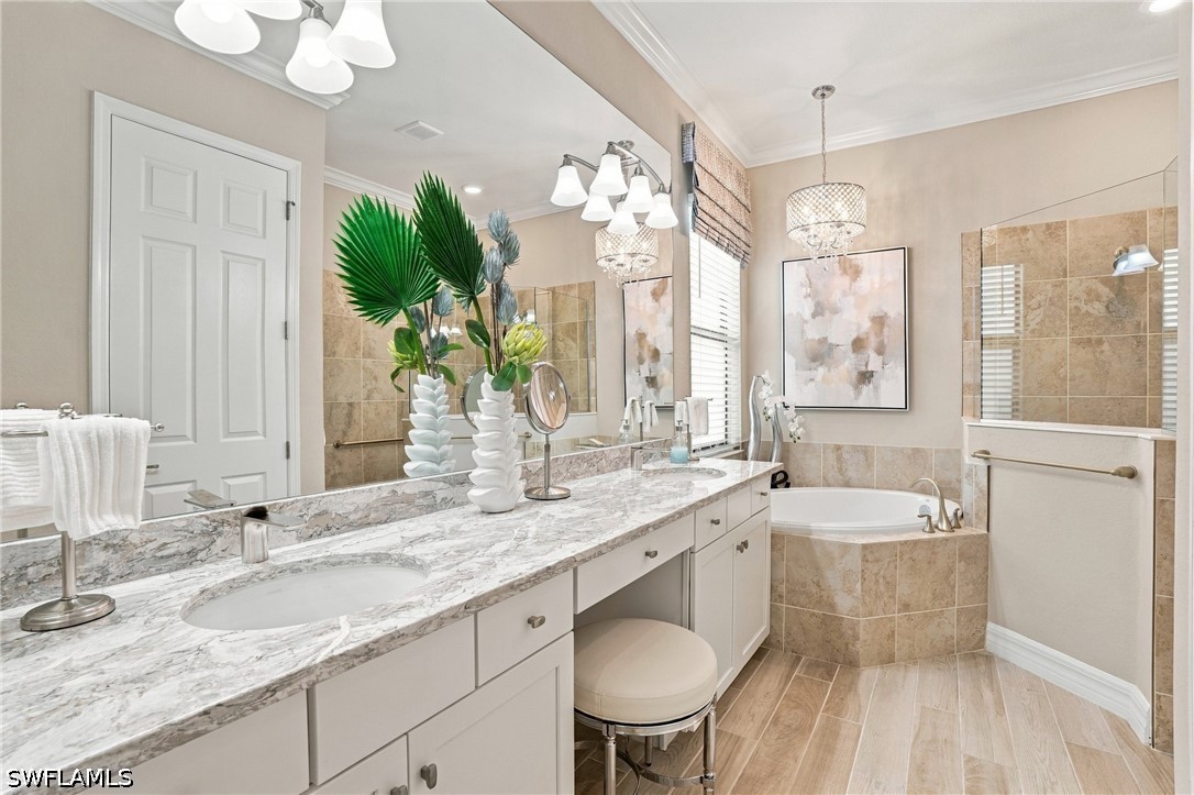 Bathroom with a long marble-look vanity, corner soaking tub, and tiled shower.