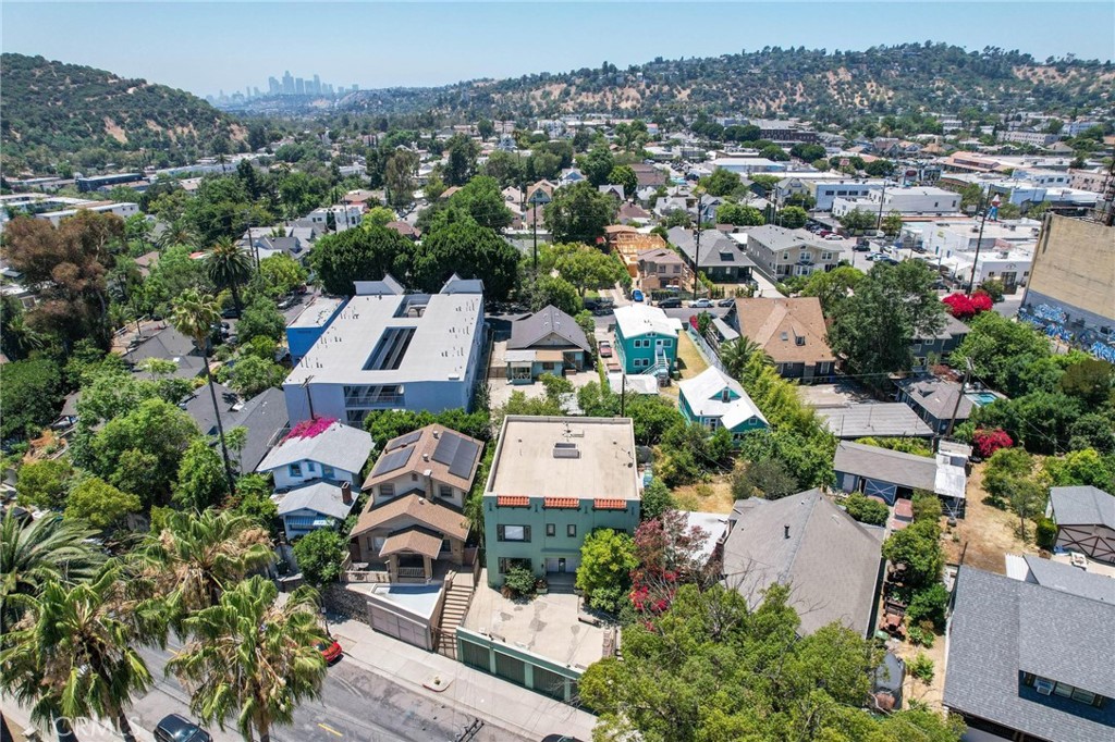 Aerial view of a Los Angeles home among hillside neighborhoods, with the downtown skyline in the distance.