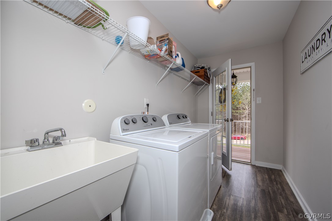 Laundry room with a utility sink, washer and dryer, wire shelves, and a glass-paneled door to the deck.