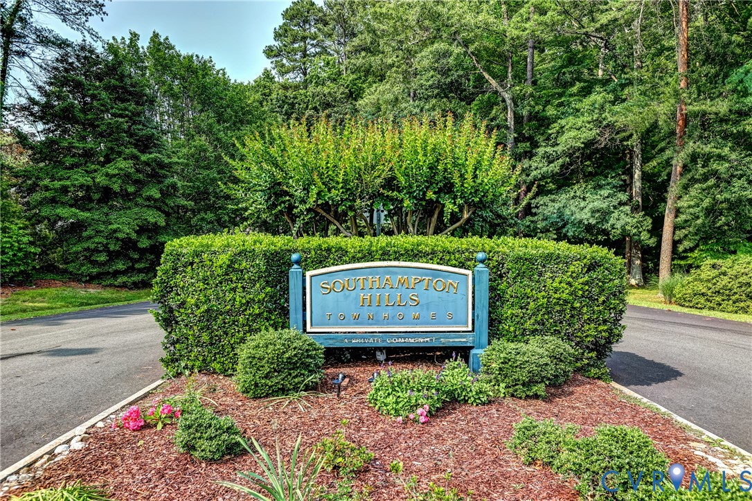 Southampton Hills Townhomes entrance sign amid trimmed hedges and flowering landscaping.