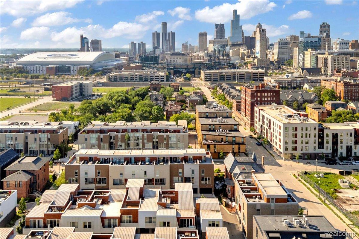 Aerial view of downtown Detroit, with residential buildings in the foreground and the skyline beyond.