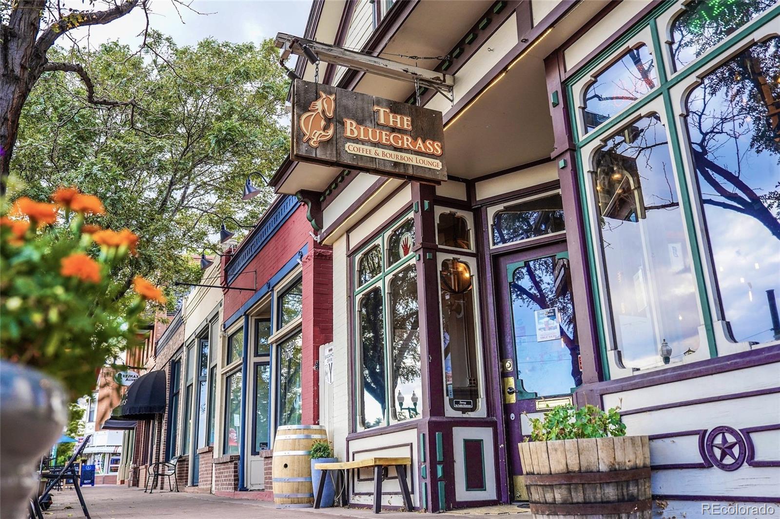The Bluegrass Coffee & Bourbon Lounge storefront with a hanging sign and colorful window trim.