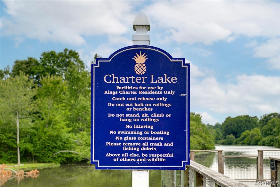 Charter Lake rules sign beside the water and a wooden dock.