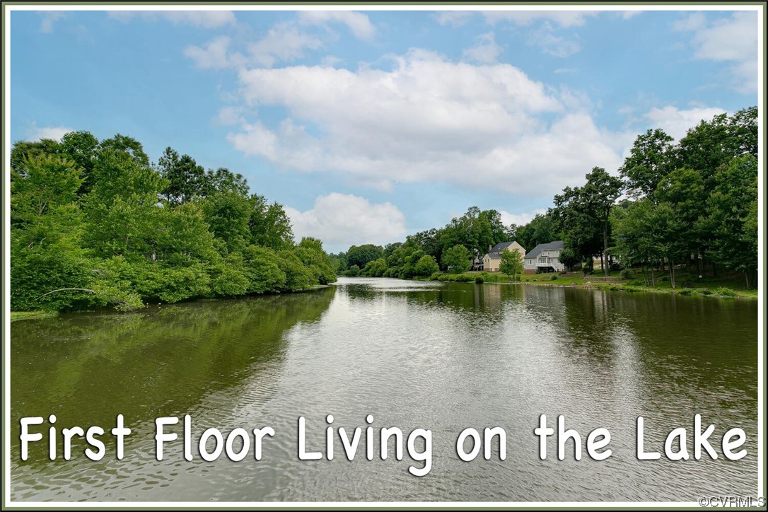 Lake view with tree-lined banks and homes across the water.