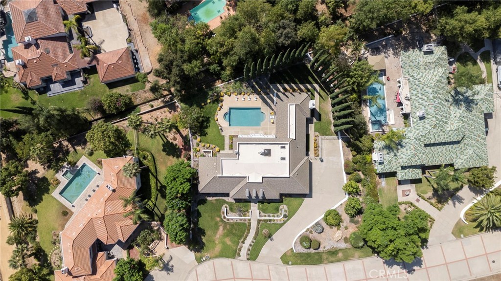 Aerial view of 5072 Castle Court, showing the home, swimming pool, and landscaped grounds.