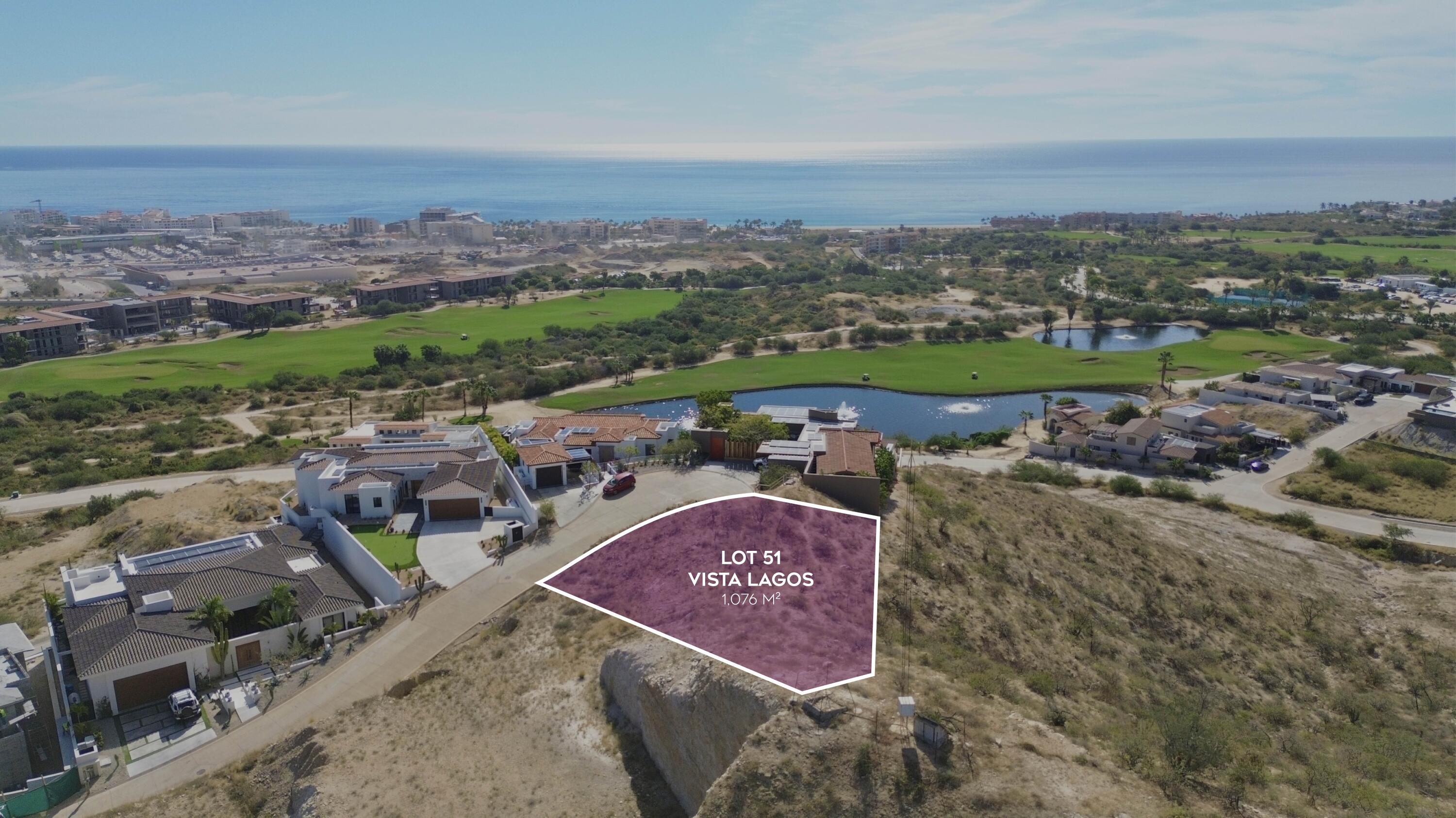 Vacant Vista Lagos lot outlined beside a golf course, with ponds and the ocean beyond.