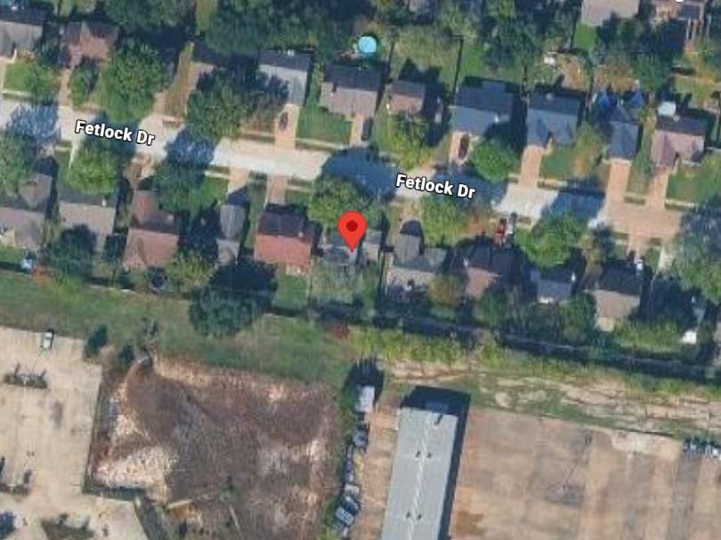 Aerial view of a home marked on Fetlock Drive, surrounded by neighboring houses and trees.