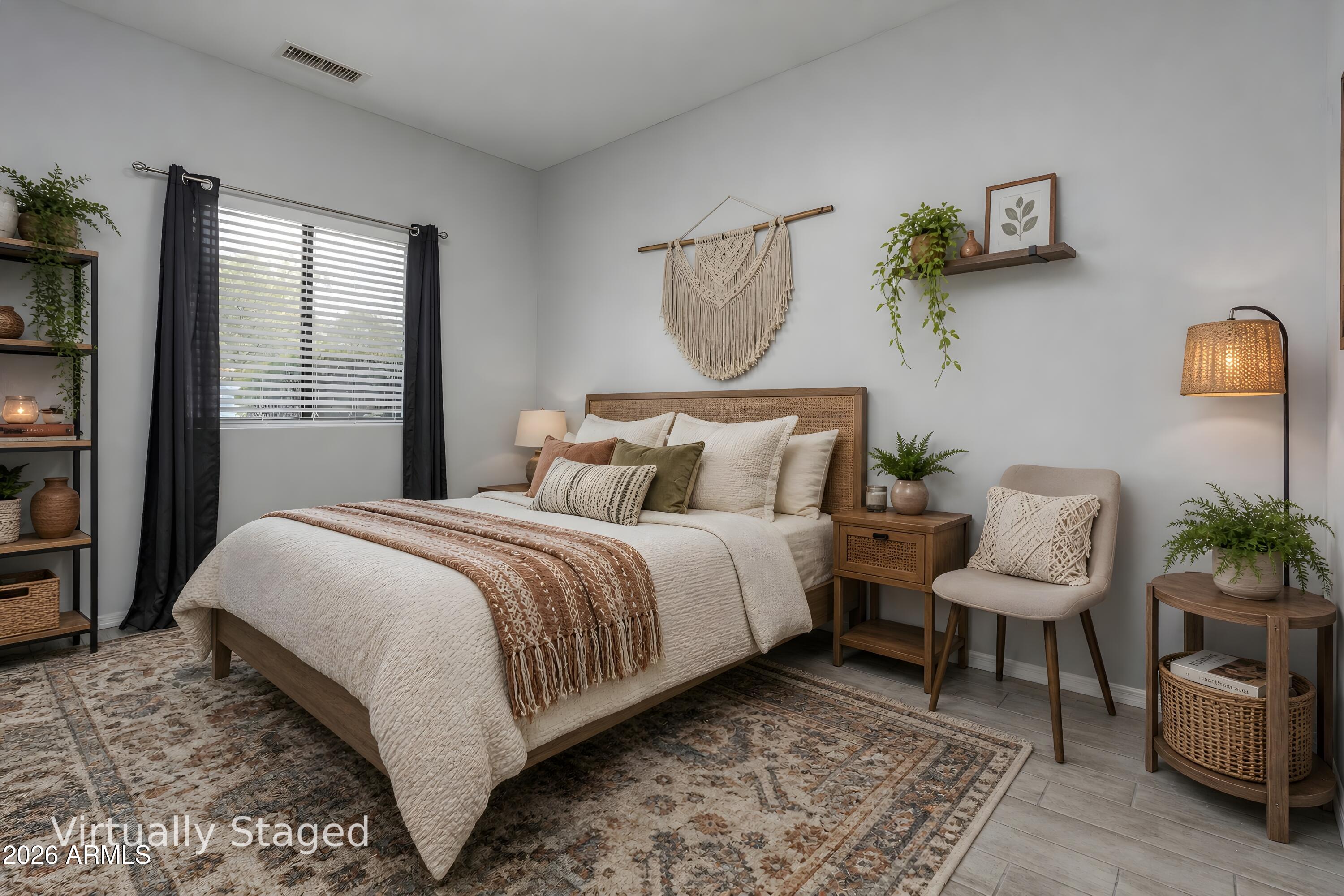 Virtually staged bedroom with a wood bed, layered neutral bedding, patterned rug, and plants.