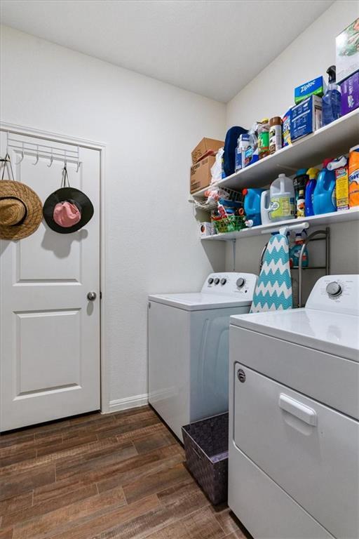 Laundry room with washer, dryer, and shelves stocked with cleaning supplies.