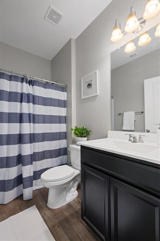 Bathroom with dark paneled vanity, white countertop, and navy-and-white striped shower curtain.
