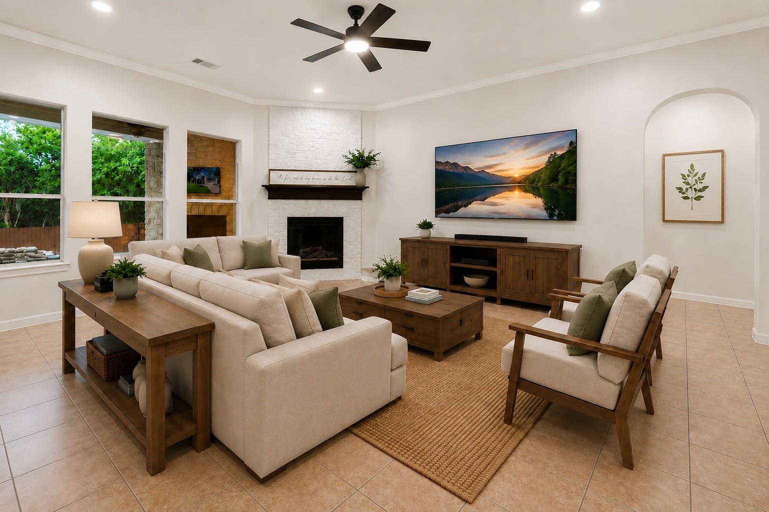 Staged living room with a white brick fireplace, cream sectional, and wood furniture.