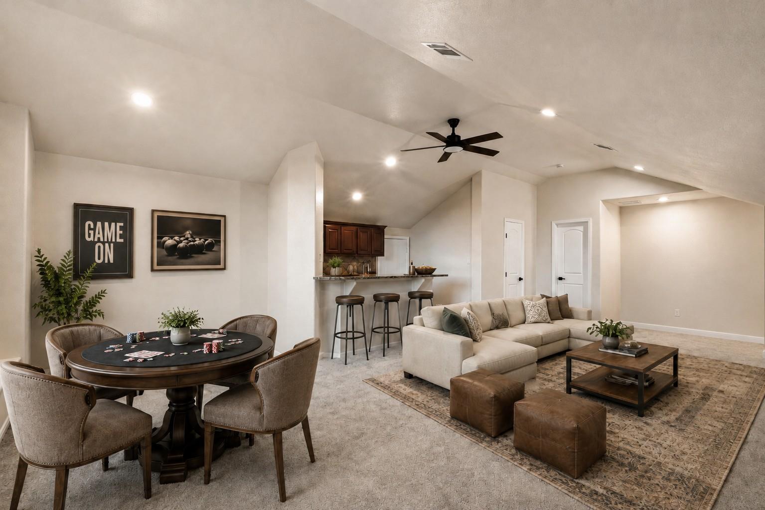 Staged game room with a poker table, bar seating, and a vaulted-ceiling lounge.