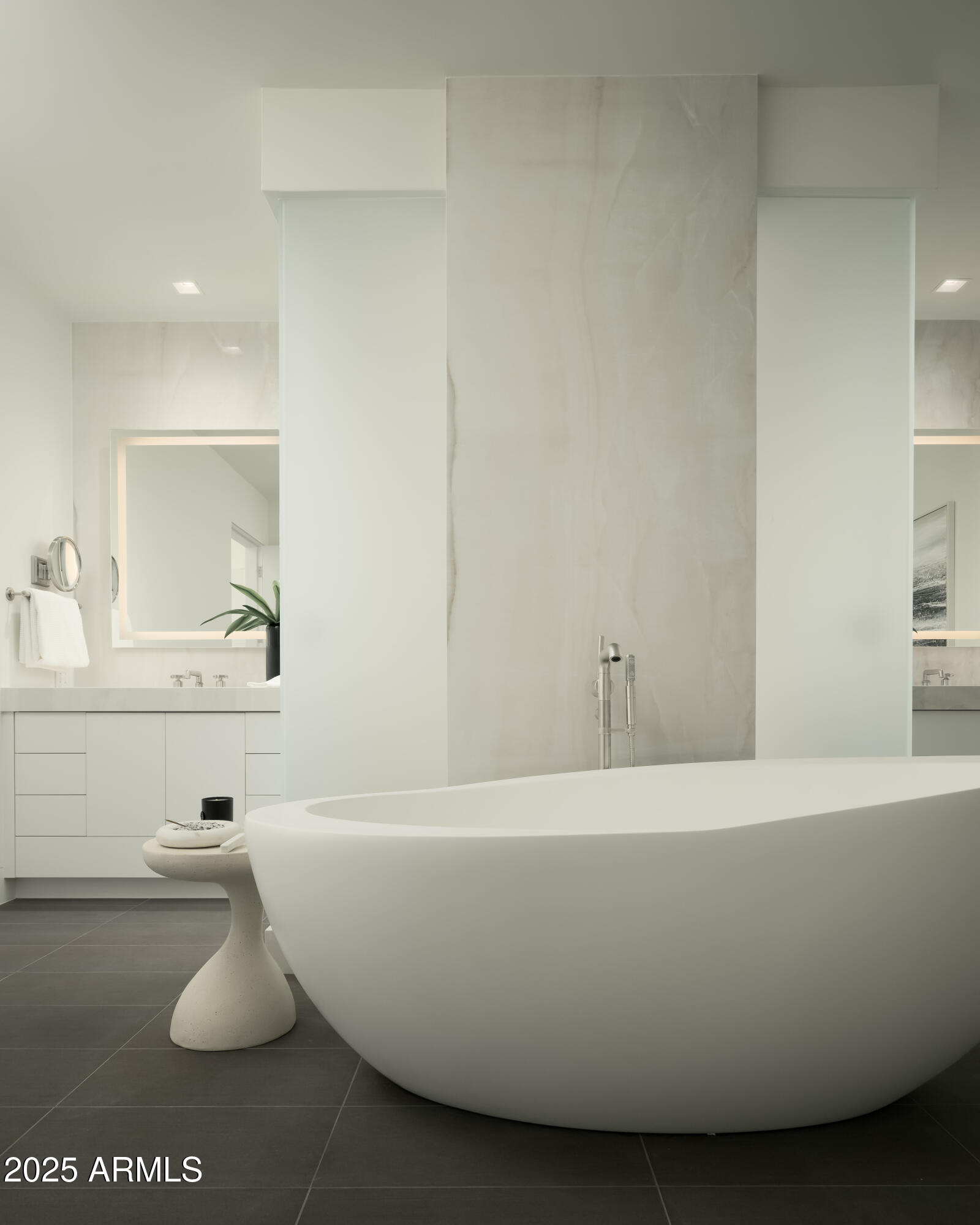 Modern bathroom with a freestanding tub, marble-look shower wall, and white vanity.