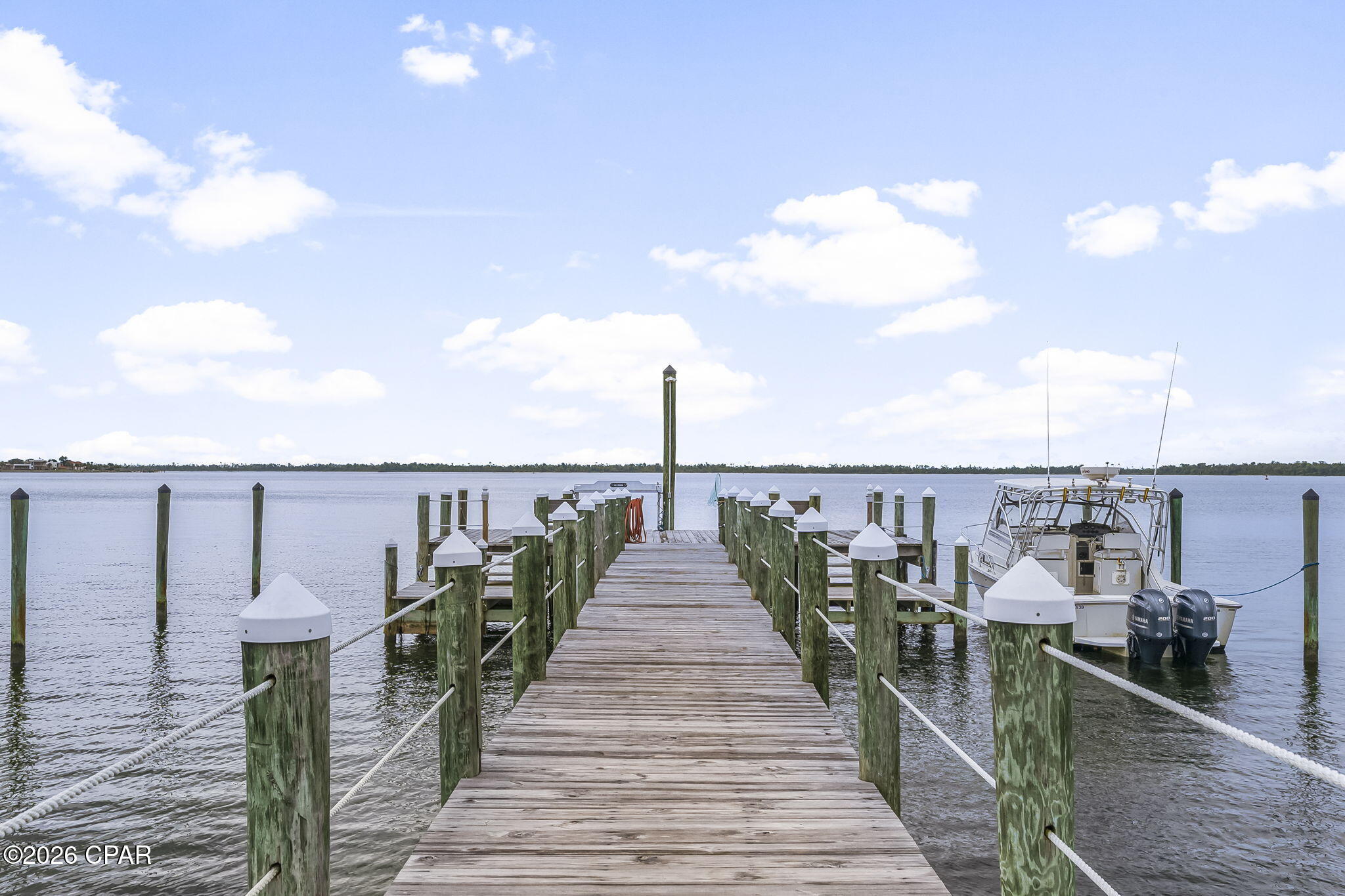 Waterfront dock with a motorboat moored beside it