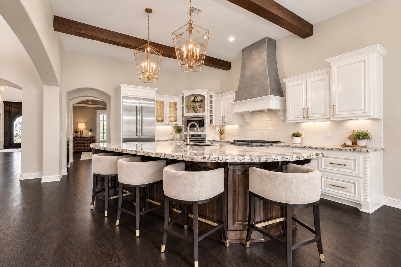 Kitchen with a large island, white cabinetry, dark wood beams, and brass pendant lights.