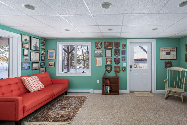 Living room with a red sofa, turquoise walls, and water visible through the windows.