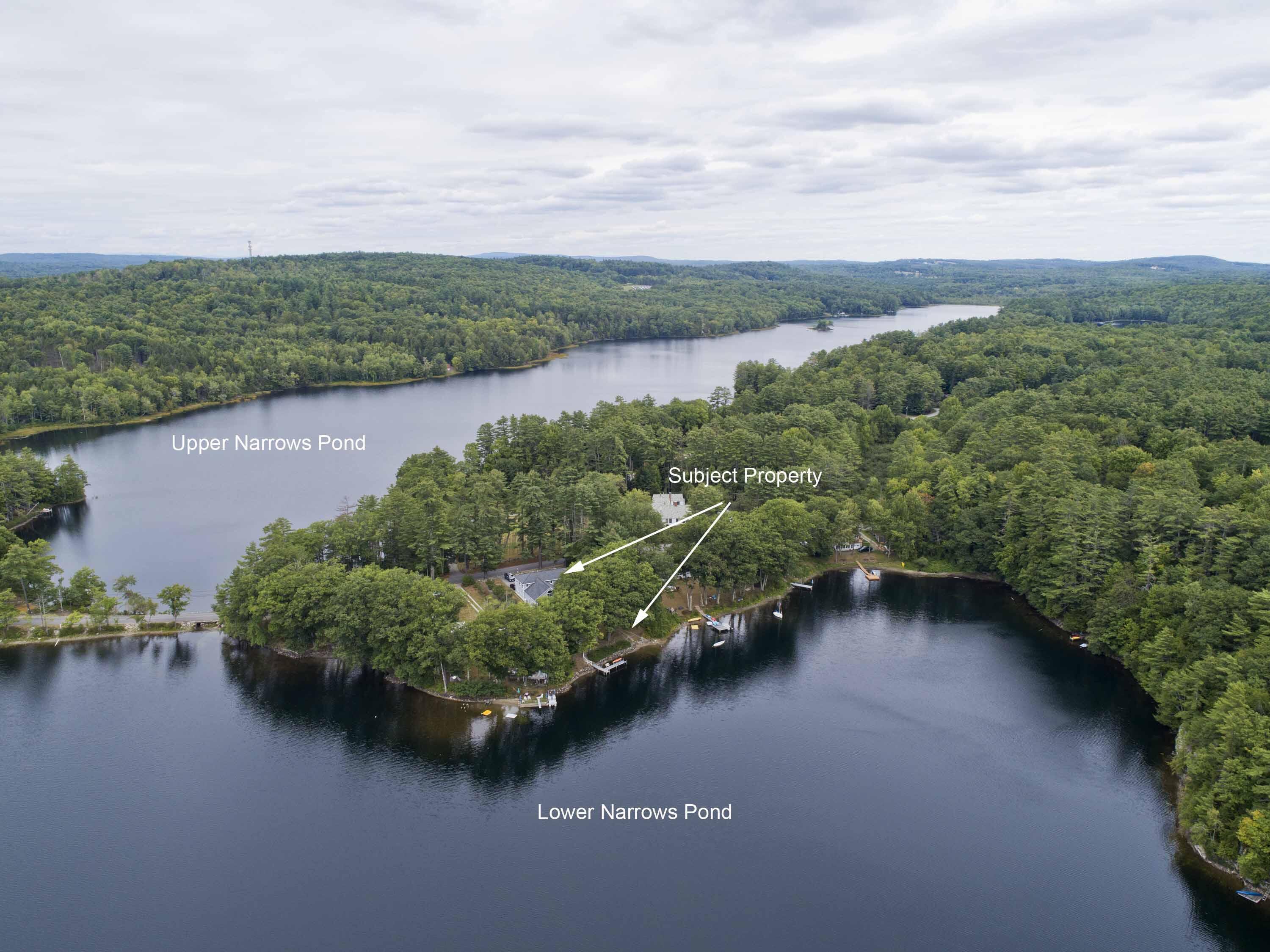 Aerial view of a wooded waterfront property between Upper and Lower Narrows Pond, with docks.