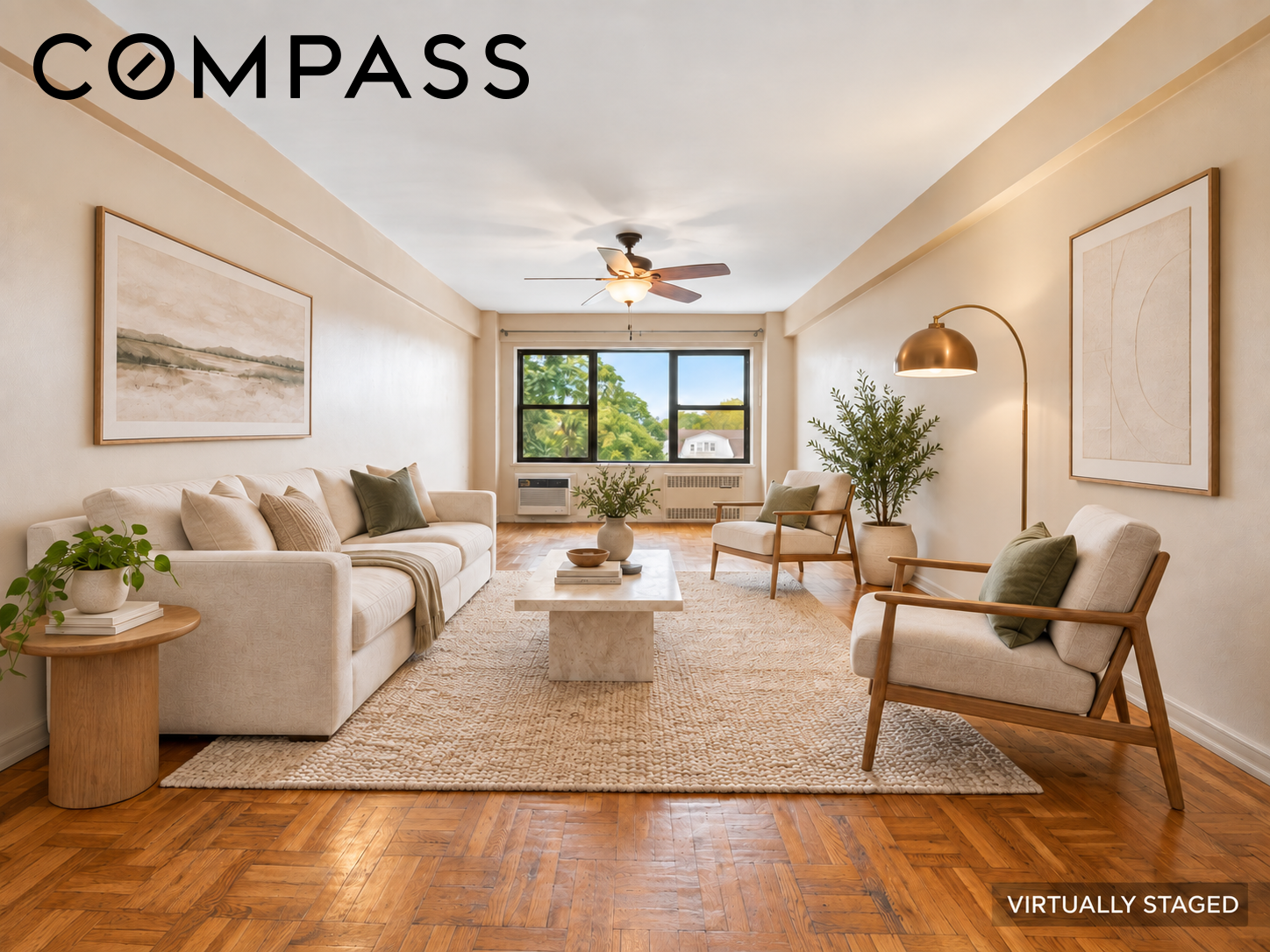 Virtually staged living room with cream seating, a textured rug, and warm parquet flooring.