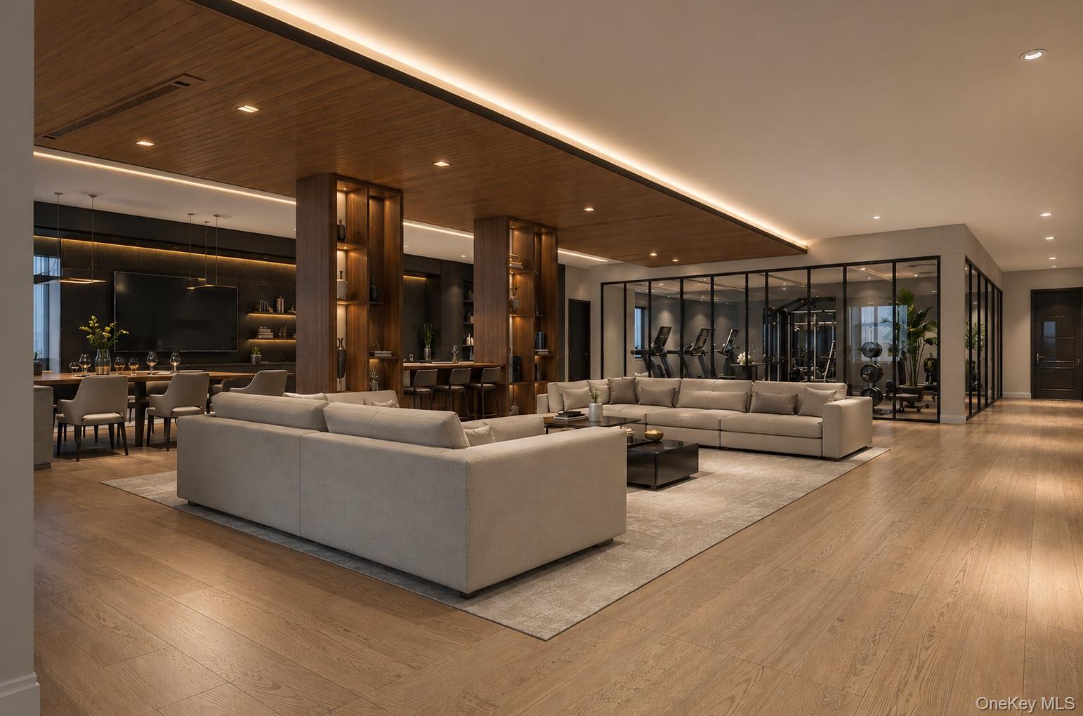 Modern living room with pale sectional sofas, a wood-paneled ceiling, and a glass-walled gym.