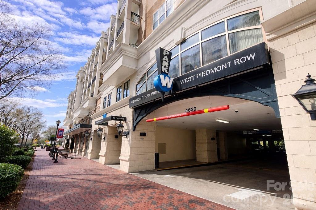 Piedmont Row building entrance with a covered parking drive and brick sidewalk.