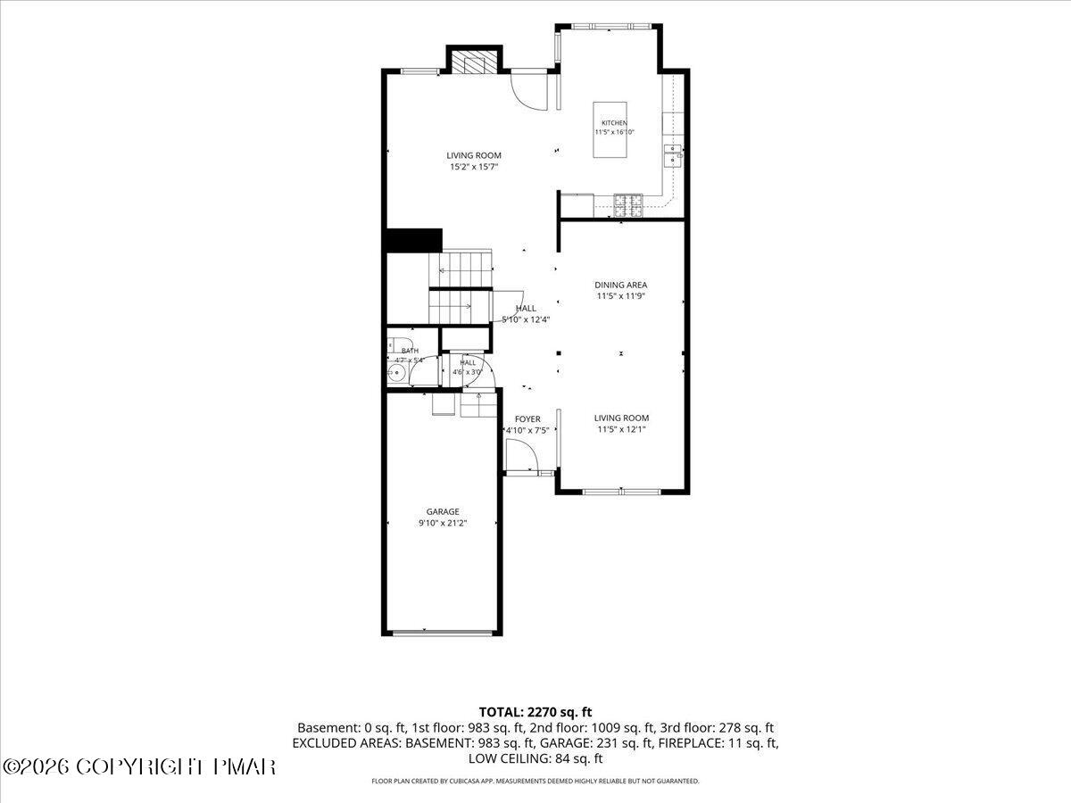 Floor plan showing the home’s kitchen, dining area, two living rooms, bath, foyer, and garage.
