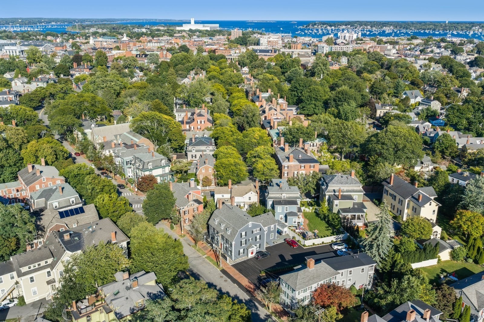 Aerial view of a tree-lined Salem neighborhood with homes and a harbor marina.