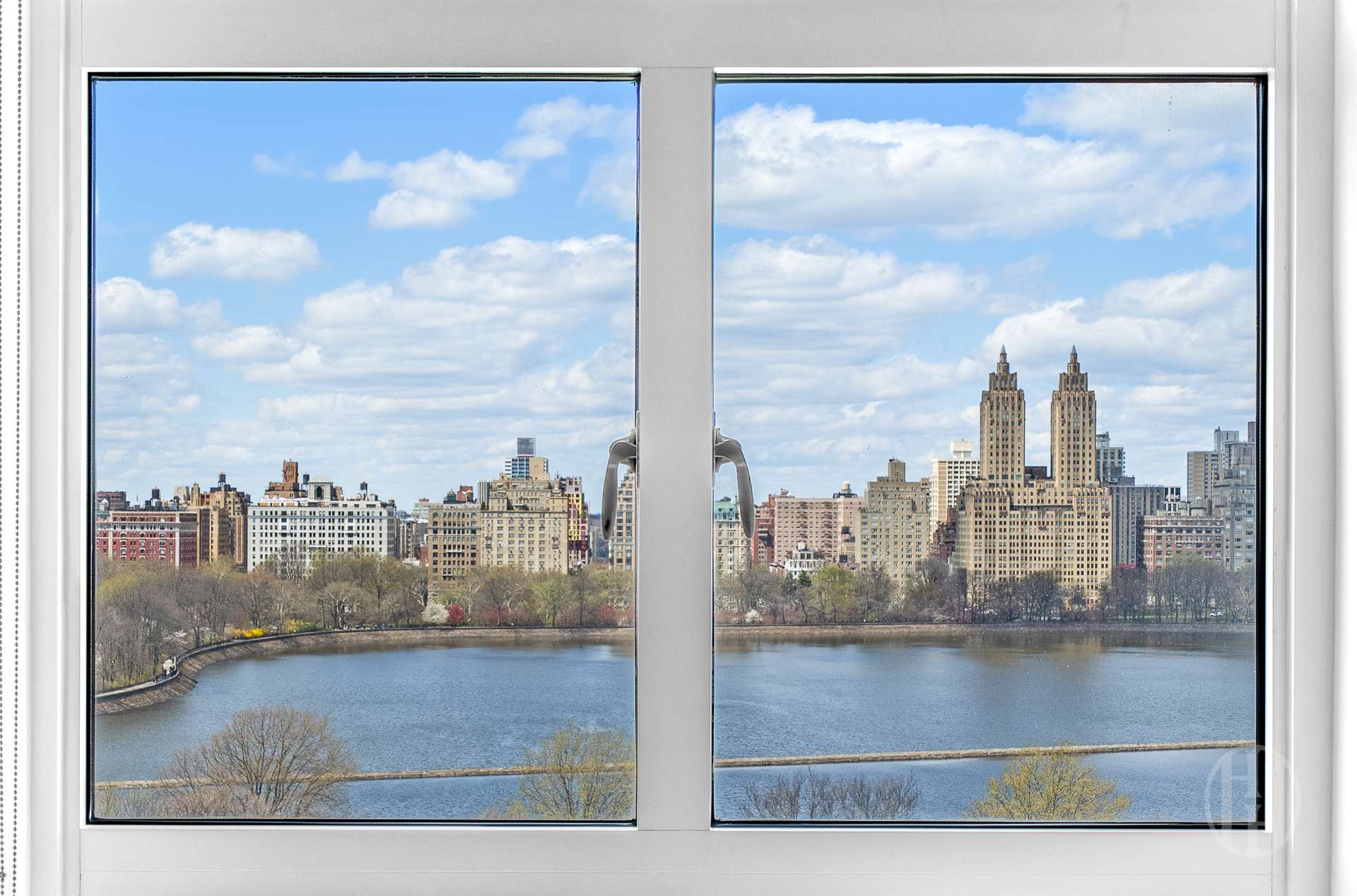 Reservoir and Manhattan skyline seen through a large apartment window.