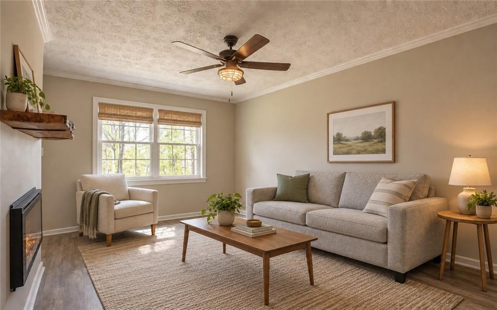 Staged living room with beige seating, a wooden coffee table, and a fireplace beside a wide window.