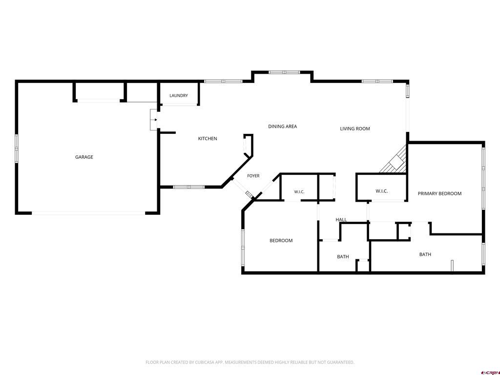 Floor plan showing a garage, open kitchen and living areas, two bedrooms, and two bathrooms.