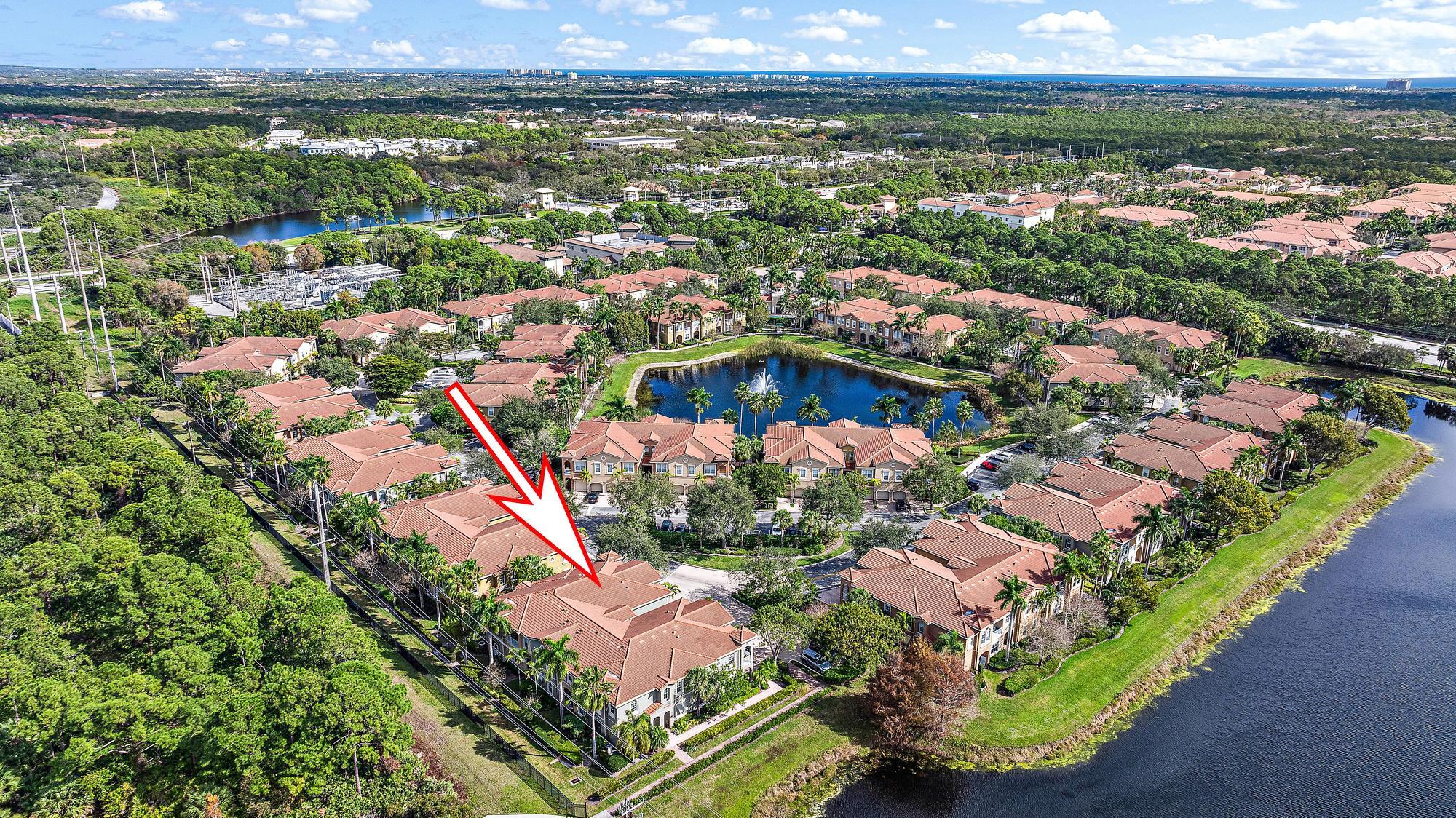Aerial view of the Bonsai 101 Circle community, with an arrow marking the home beside a lake.