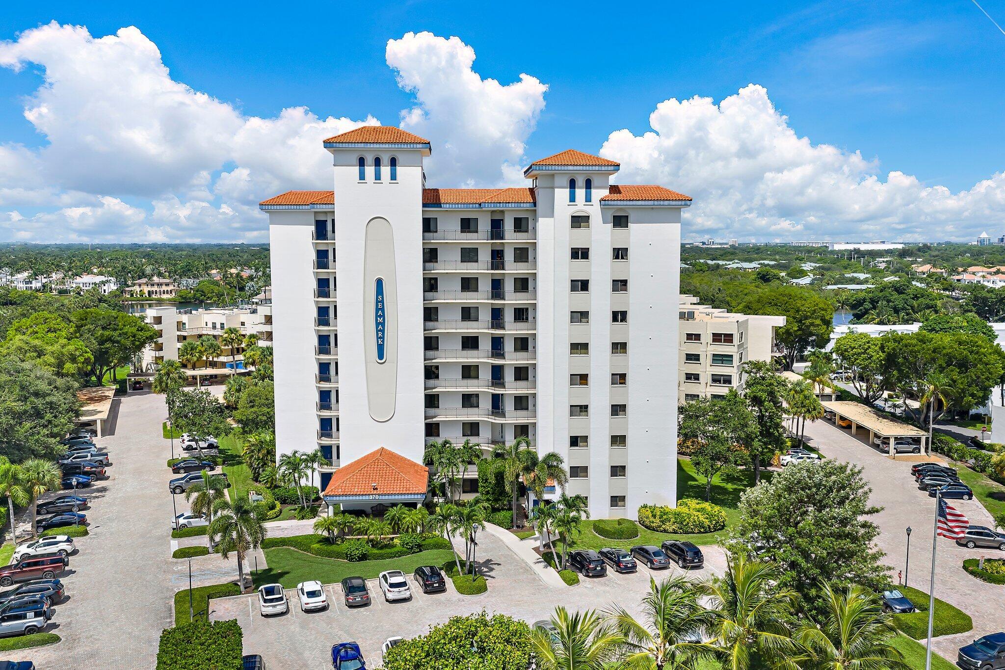 Aerial view of the white Seamark condominium, with terracotta roofs, balconies, and landscaped grounds.