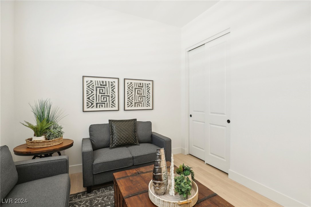 Living room with gray sofas, geometric wall art, and a wooden coffee table topped with succulents.