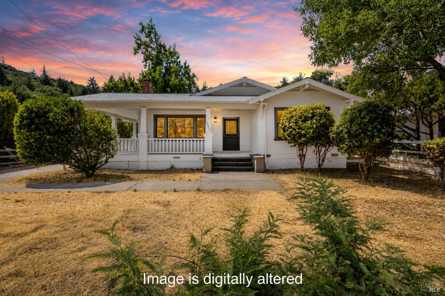 White single-story home with a covered front porch beneath a pink sunset sky.