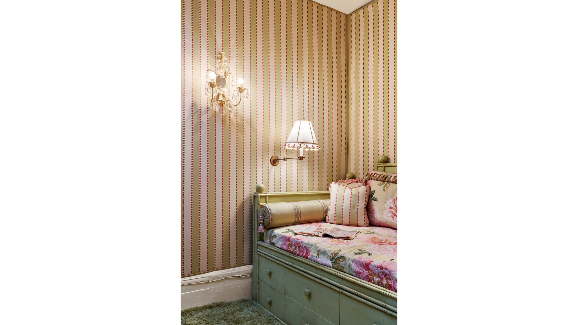 Bedroom with a green built-in daybed, floral bedding, and red-and-cream striped wallpaper.