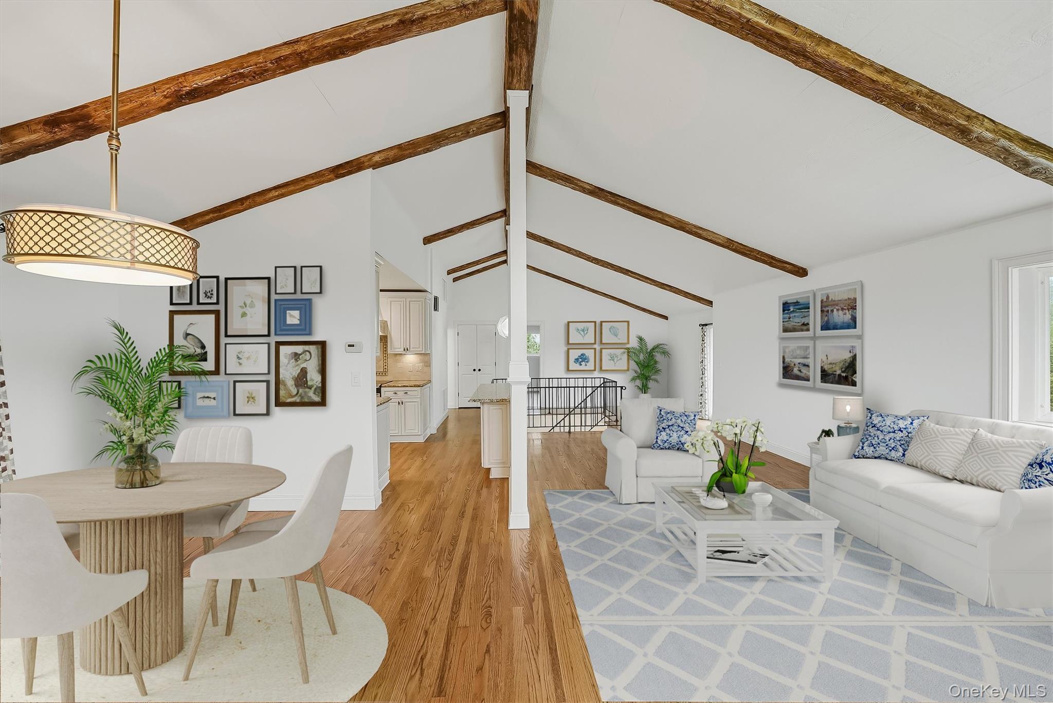 Open-plan living and dining room with vaulted ceilings, exposed wood beams, and hardwood floors.