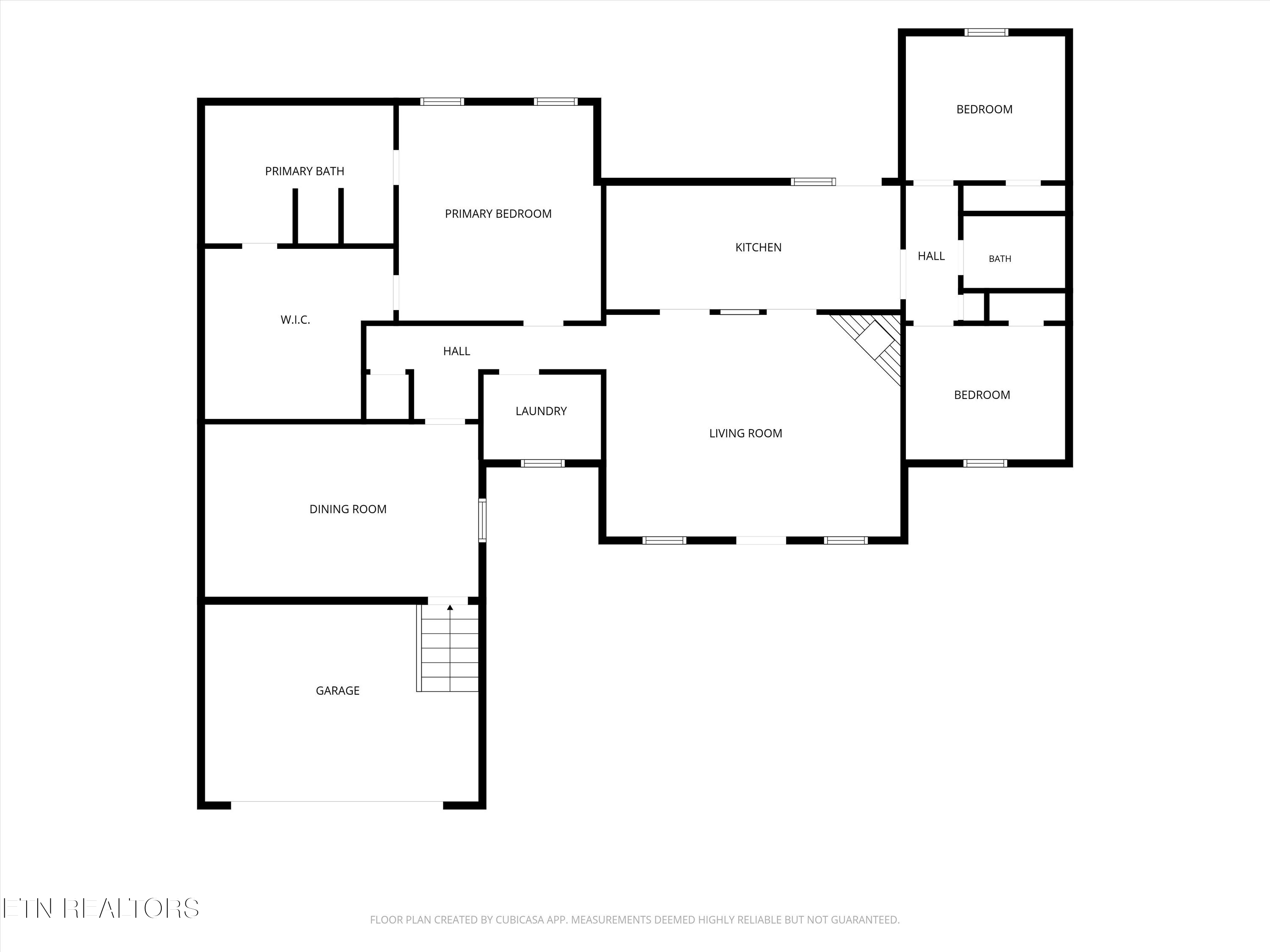 Floor plan showing three bedrooms, two bathrooms, kitchen, living and dining rooms, laundry, and garage.
